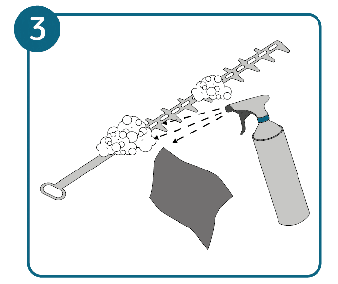 Cleaning the cutting blade of the hedge trimmer with cleaning agent and cloth